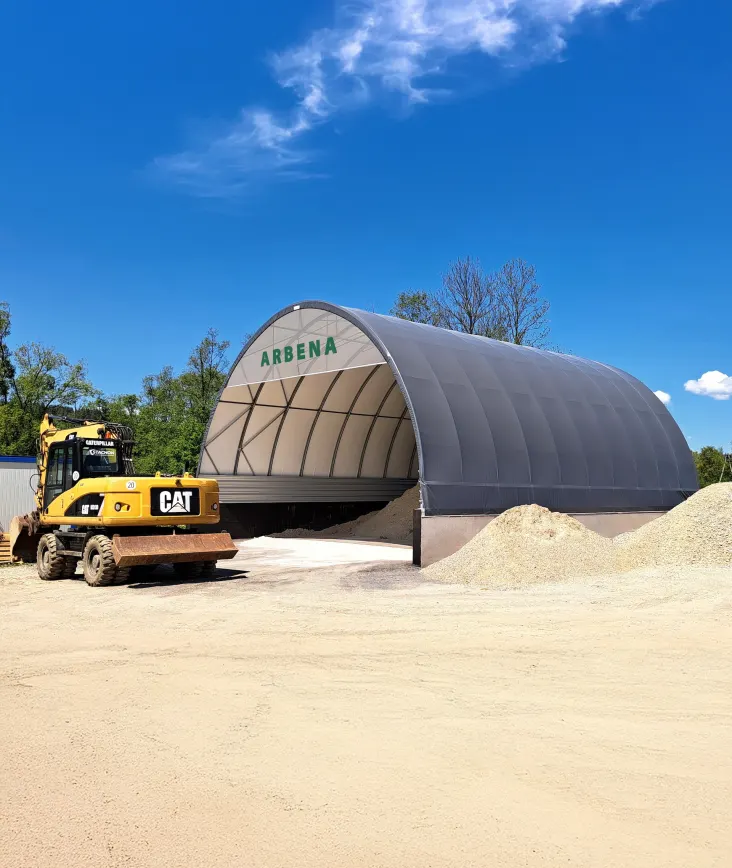 ARBENA building over aggregate storage, with a wheel loader