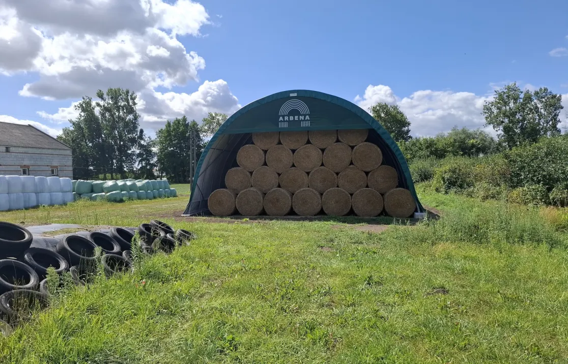 ARBENA shelter with round bales stacked inside