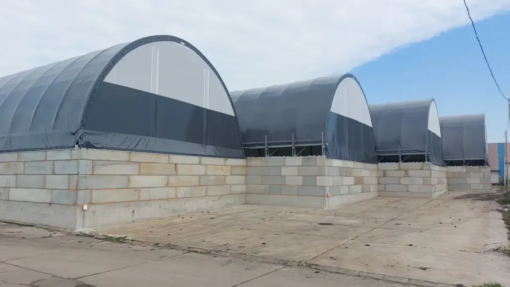 Row of ARBENA arch buildings standing on walls of concrete blocks