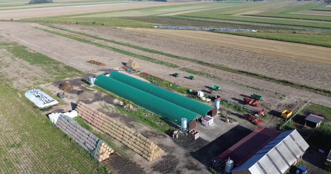 Two green ARBENA poultry buildings on a farm in Greater Poland, aerial view