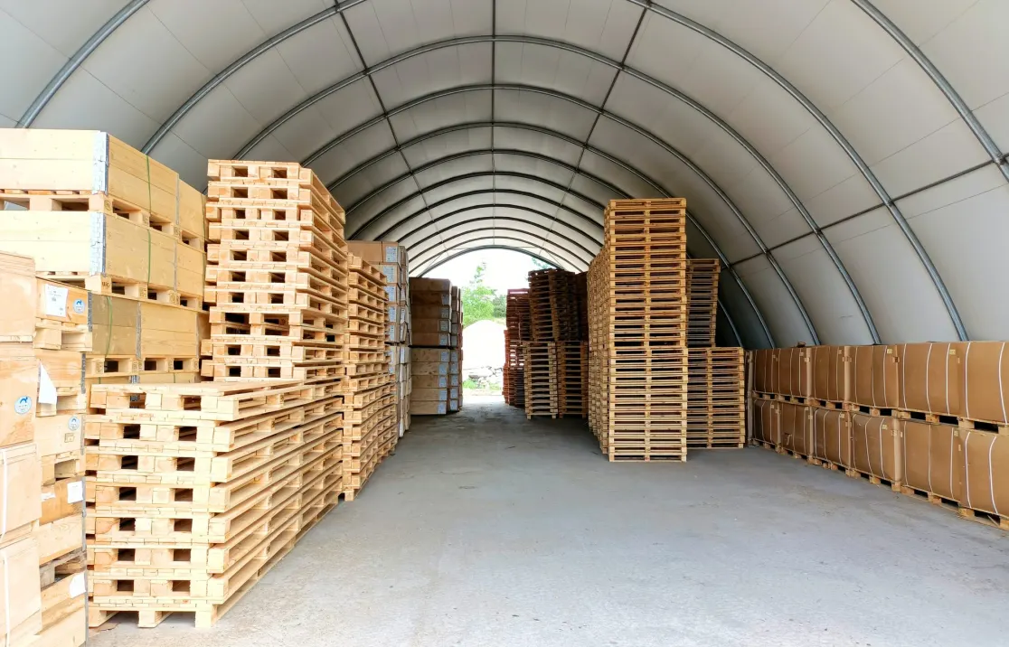 Pallets and goods stored inside an ARBENA arch building