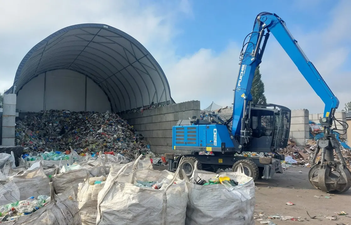 ARBENA arch over a recycling yard, with a material handler